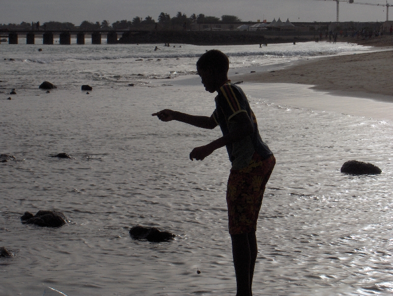 Boy fishing from the rocks, Santa Maria Cape Verde