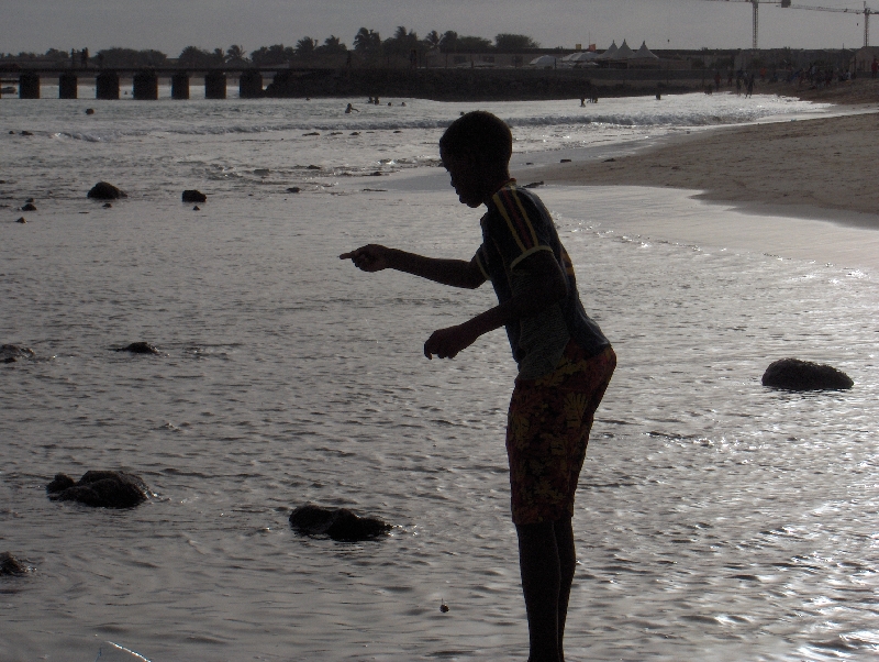 Boy fishing from the rocks, Cape Verde