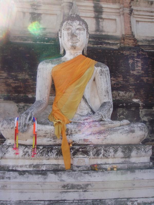 White Buddha statue in golden sarong, Thailand