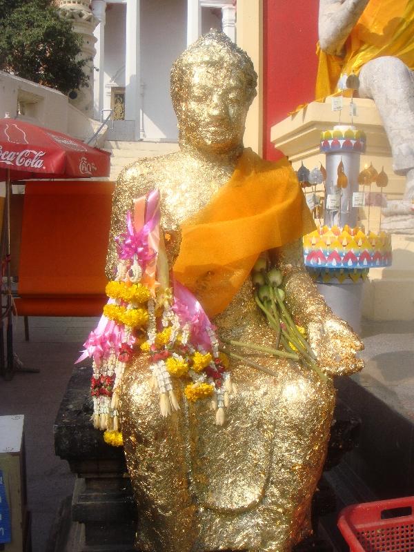 Buddha statue covered in flowers, Thailand