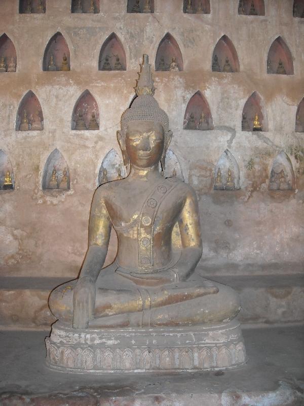 Lare Buddha statue in front of smaller ones, Vientiane Laos