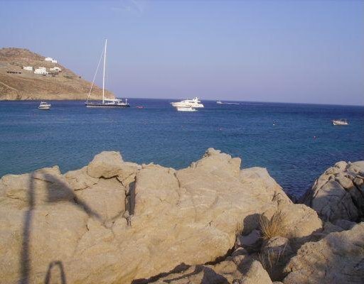 Cruising around Mykonos with our rental scooter., Greece