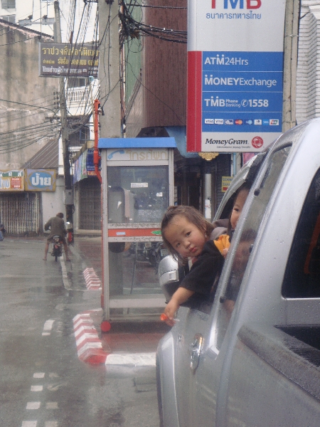 Thai Children in the rain in Chiang Mai, Thailand