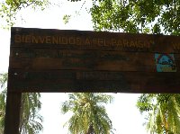 Welcome sign of Camping El Paraiso near Santa Marta with telephone number, Colombia.