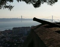 Old canon in Lisbon with a view of the Lisbon Bridge 