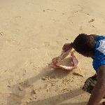Kid playing with shark's mouth, Santa Maria Cape Verde