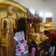 Thai family paying respect to the Buddha