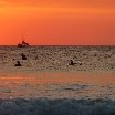 Surfers cathing the waves under a spectacular sunset in Tamarindo, Tamarindo Costa Rica