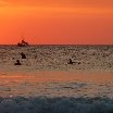 Tamarindo Costa Rica Surfers cathing the waves under a spectacular sunset in Tamarindo